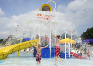 Children wait for an oversized bucket to overflow with water at the Franklin Family Aquatic Center. Families wore their red, white and blue in honor of Independence Day. Caitlin O'Hara / Daily Journal